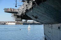 Sailboat Framed by USS Midway and USS Carl Vinson