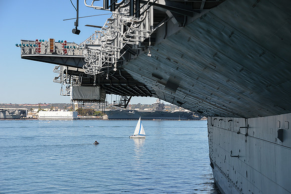 Sailboat Framed by USS Midway and USS Carl Vinson